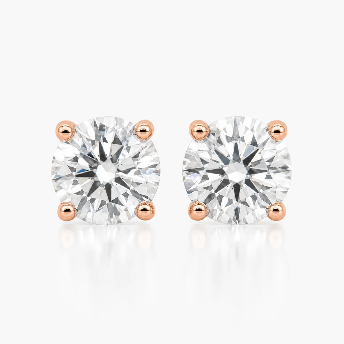 Four-claw studs diamond earrings in 18k rose gold, round diamond, made to order by Prodiam (rendered design reference)