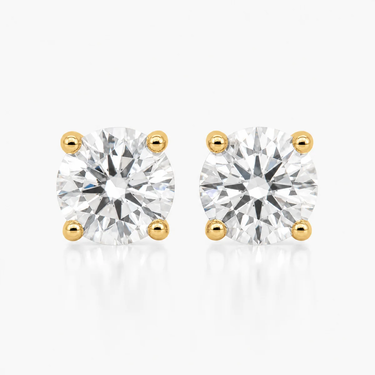 Four-claw studs diamond earrings in 18k yellow gold, round diamond, made to order by Prodiam (rendered design reference)