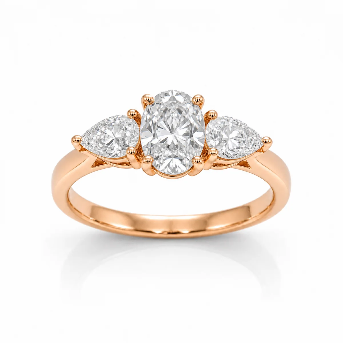 Three-stone pear sides engagement ring in 18k rose gold, oval diamond, made to order by Prodiam (rendered design reference)