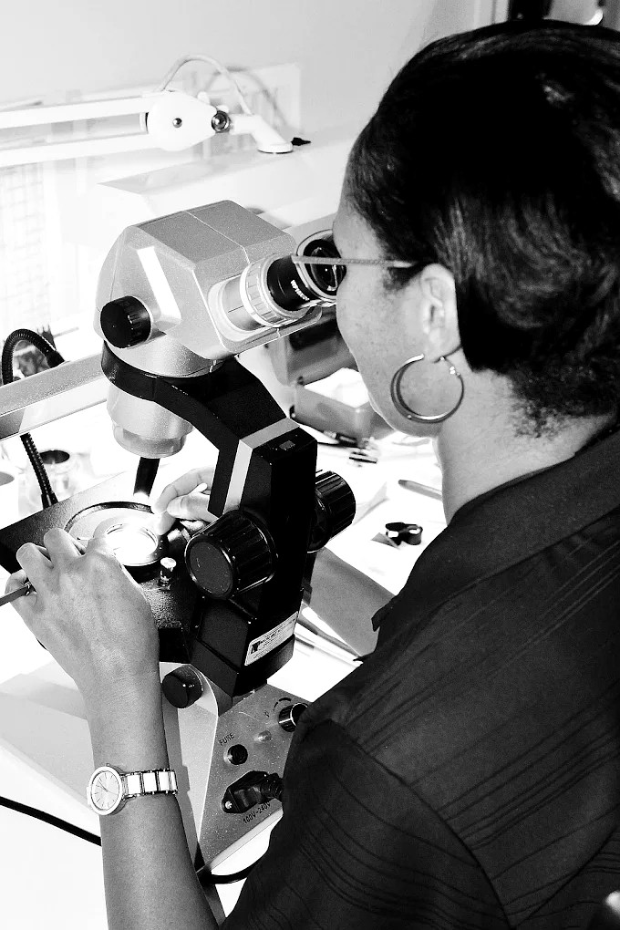 A Prodiam gemmologist inspecting a diamond under a stereo microscope at the Bedfordview premises
